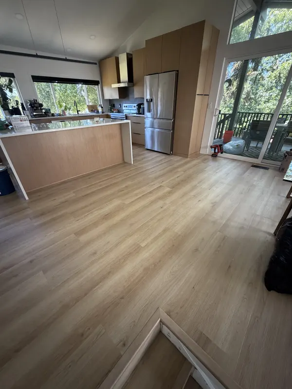 Light oak through an open plan kitchen with a run of tall windows