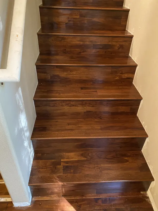 Dark walnut treads and risers on a full flight of stairs