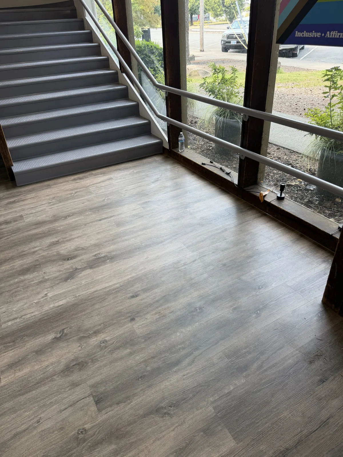 Plank floor running past an open staircase in a split level home