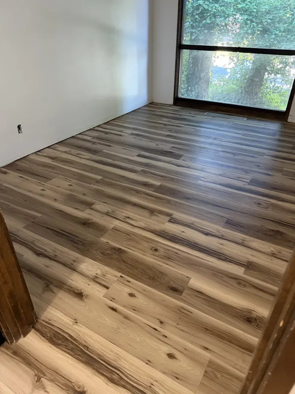 Rustic hickory plank laid through a room with a window seat