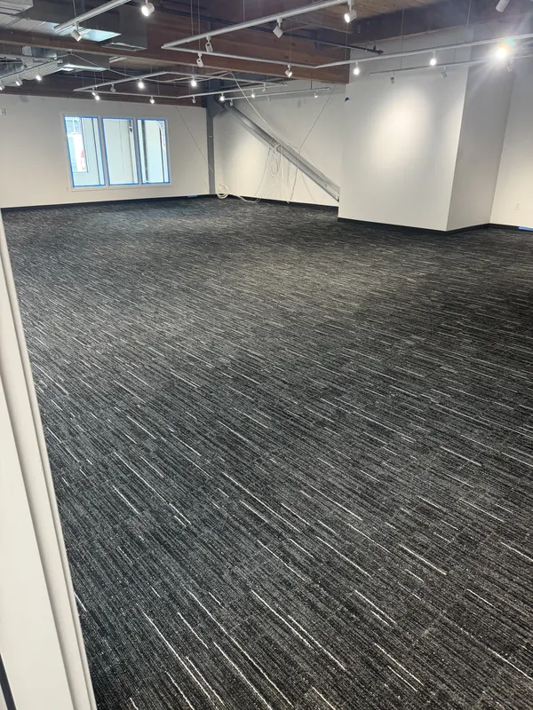 Carpet laid wall to wall across a large open floor