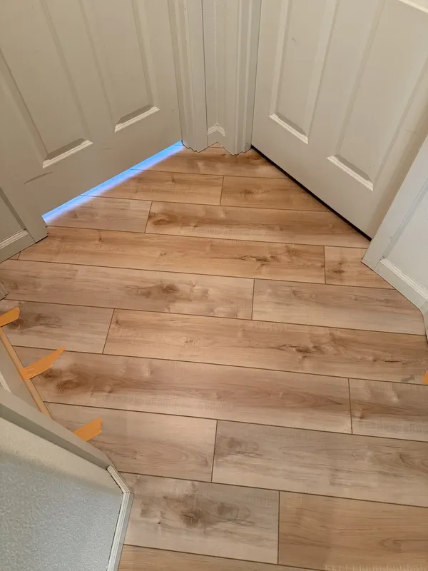 Plank samples laid out on the floor they are about to go next to