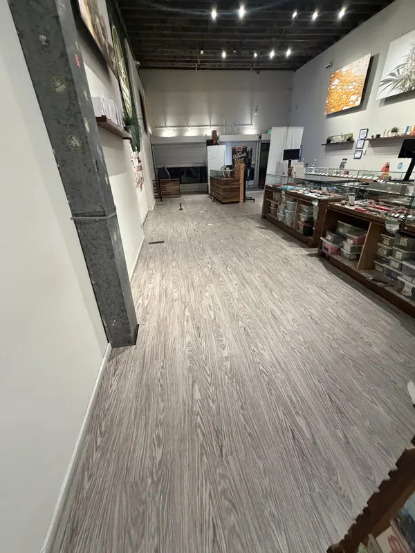 Grey plank floor through a fitted out retail space with display cases