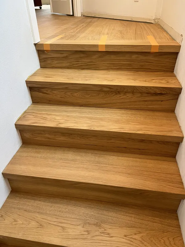 Honey oak treads on a staircase turning at a landing